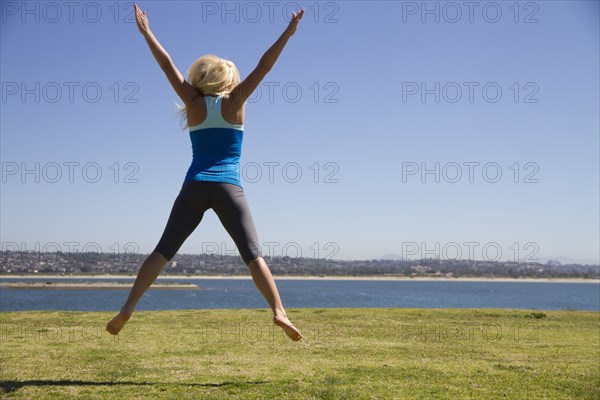 Woman jumping for joy in field