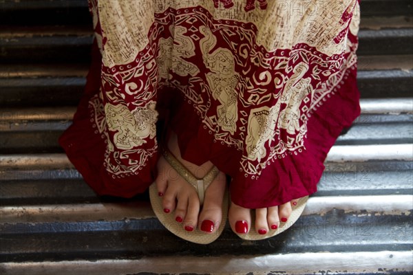 Close up of woman in traditional skirt and flip flops