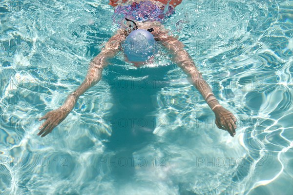 High angle view of Caucasian woman swimming in pool