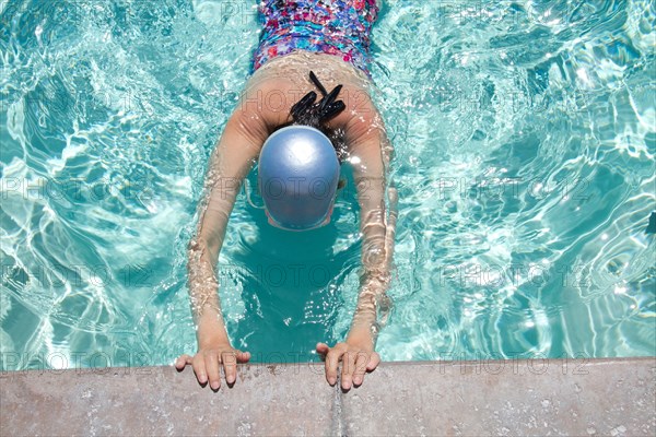 High angle view of Caucasian woman swimming in pool