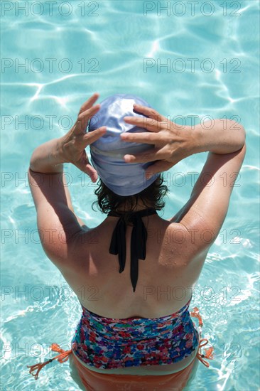 High angle view of Caucasian woman standing in pool