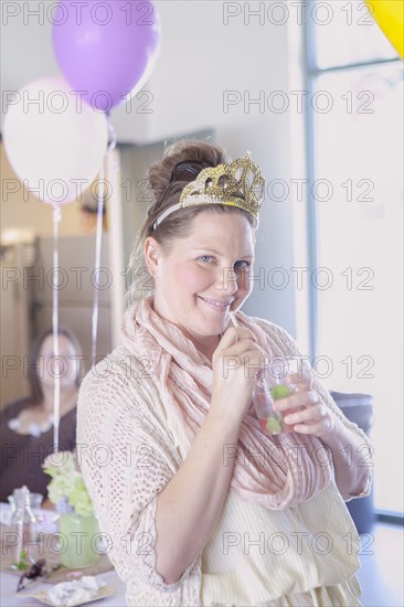 Caucasian woman drinking cocktail at party