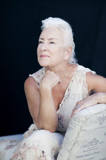 Caucasian woman leaning on chair back