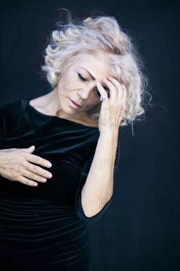 Close up of woman touching her forehead