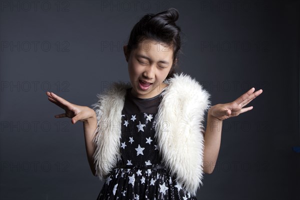 Asian girl dancing in furry vest