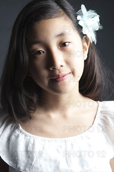 Smiling Asian girl wearing flower in her hair
