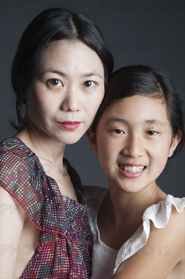 Asian mother and daughter hugging