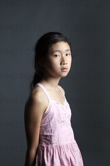 Serious Asian girl wearing dress