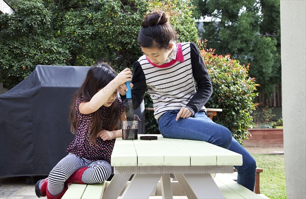 Mother and daughter playing in backyard