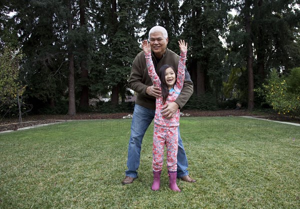 Father and daughter playing in backyard