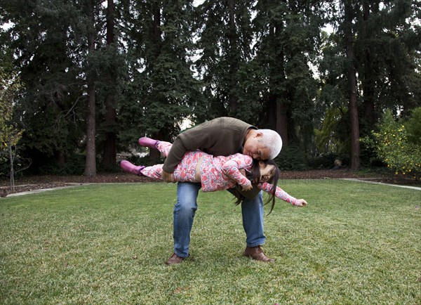 Father and daughter playing in backyard