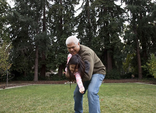 Father and daughter playing in backyard