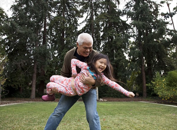 Father and daughter playing in backyard