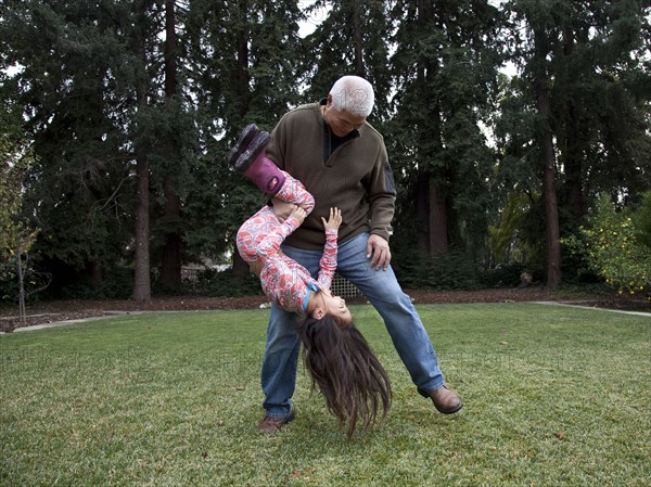 Father and daughter playing in backyard