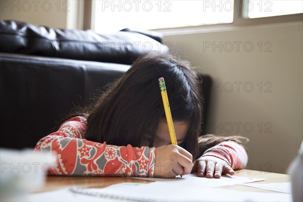Close up of mixed race girl doing homework