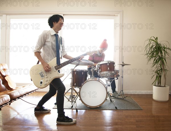 Couple playing music in living room