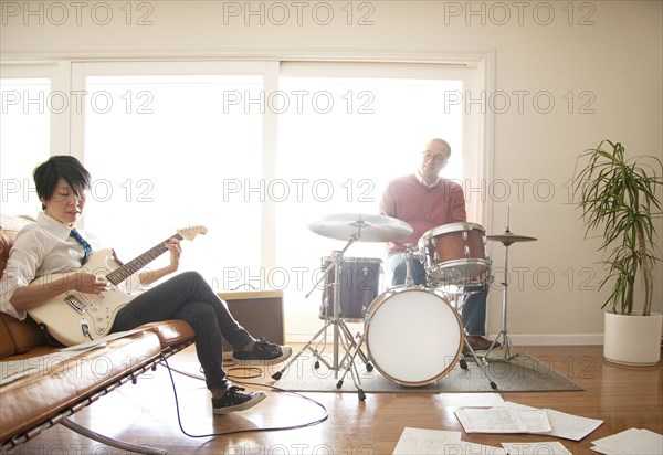 Couple playing music in living room