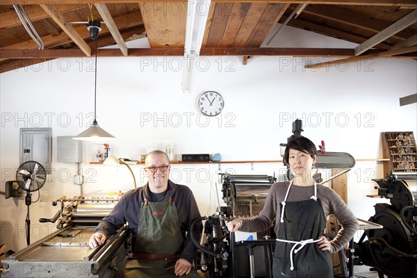 Entrepreneurs smiling in print shop