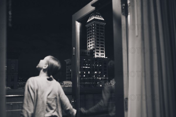 Girl admiring view from balcony doorway