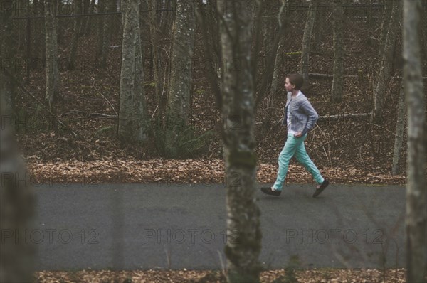 Girl walking on rural road