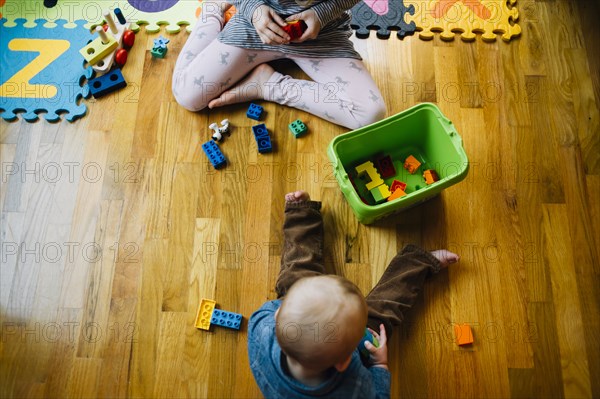 Brother and sister playing on floor