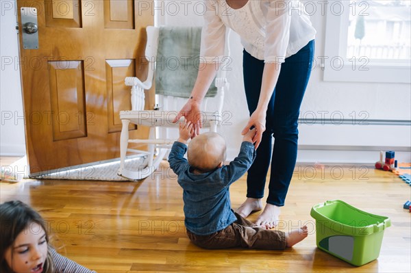 Mother and children playing near doorway