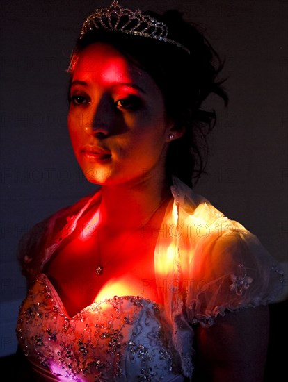 Pensive teenage girl wearing in quinceanera dress