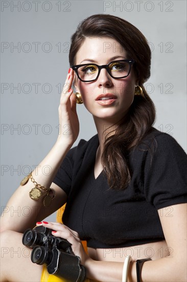 Sly woman holding binoculars