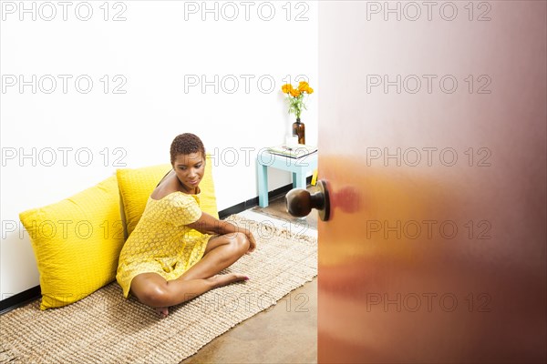 Black woman stretching on floor