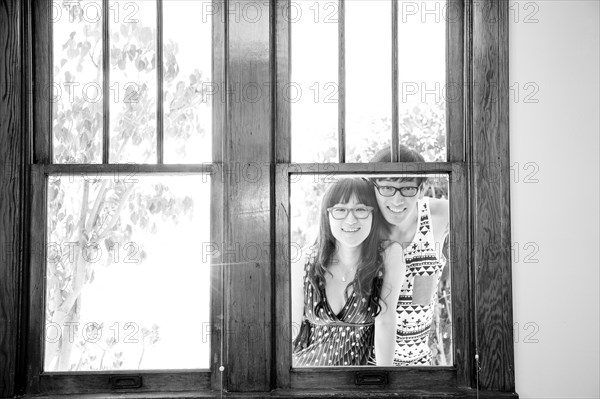 Asian couple looking through window