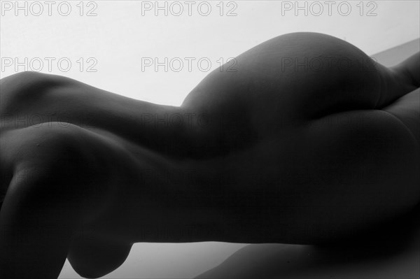 Rear view of midsection of nude woman