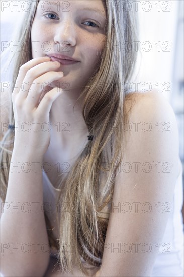 Smiling girl resting chin in hand