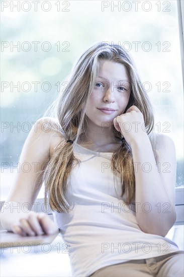 Smiling girl leaning on table