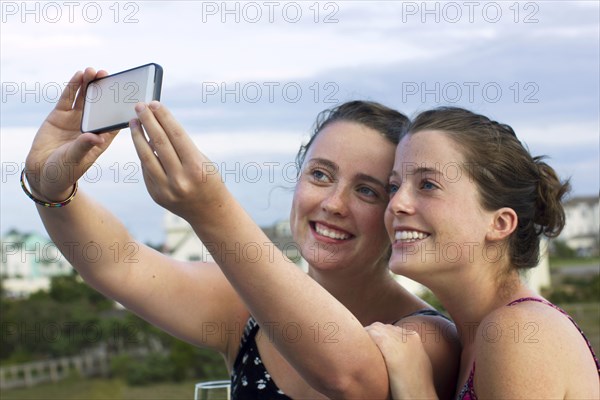 Caucasian women taking selfie with cell phone