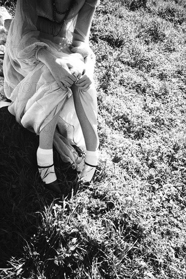 High angle view of woman sitting in grass