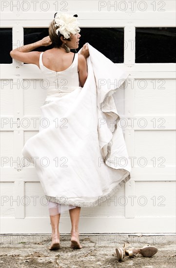 Bride peeking inside garage window