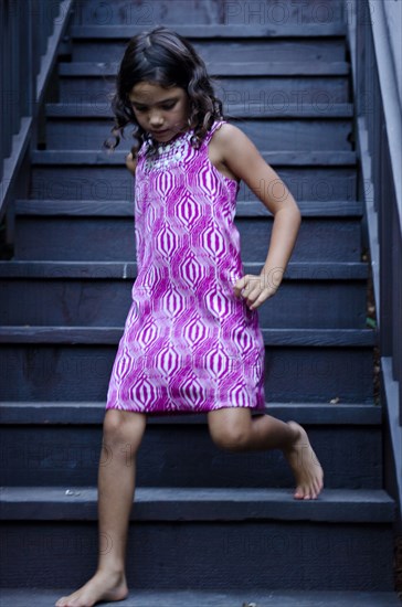 Caucasian girl walking on steps