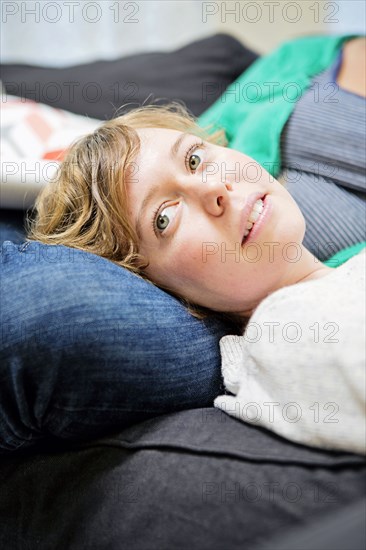 Lesbian couple relaxing on sofa in living room