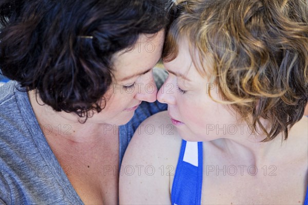 Close up of lesbian couple touching foreheads