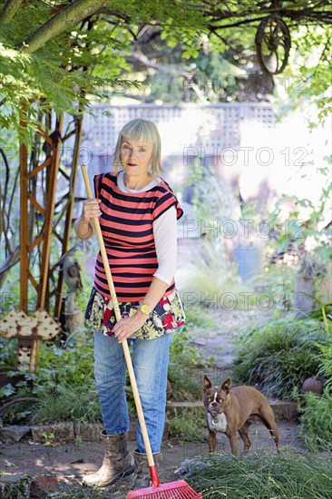 Older Caucasian woman gardening in backyard