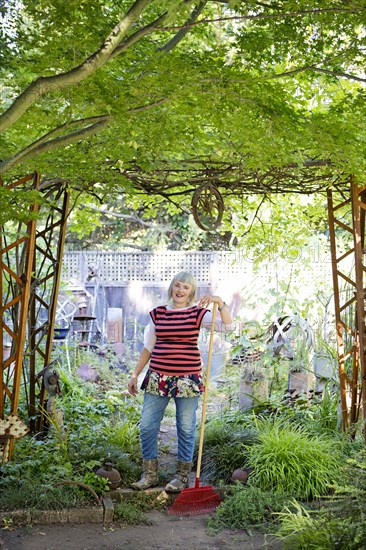 Older Caucasian woman gardening in backyard