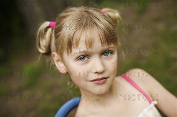 Close up of smiling girl siting in backyard