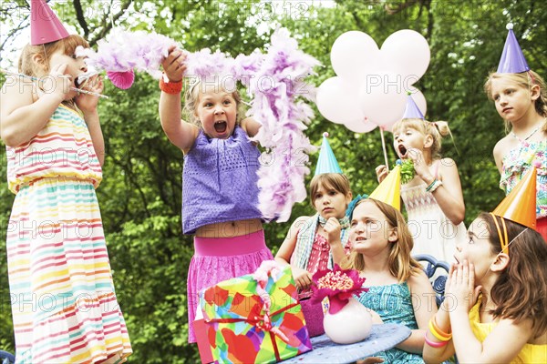 Girls cheering at birthday party outdoors