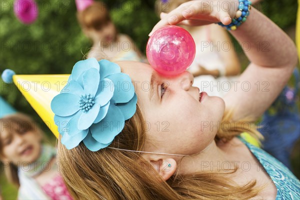 Close up of girl balancing ball on her nose