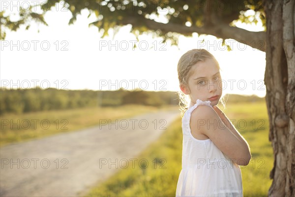 Caucasian girl standing in rural field