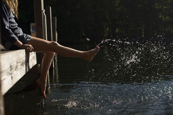 Girl splashing water in lake