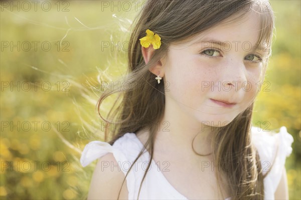 Caucasian girl wearing flower in her hair