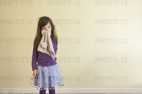 Sick Caucasian girl wiping nose