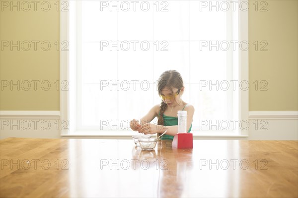 Caucasian girl cooking at table