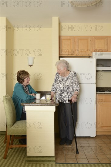 Caucasian older women relaxing in kitchen